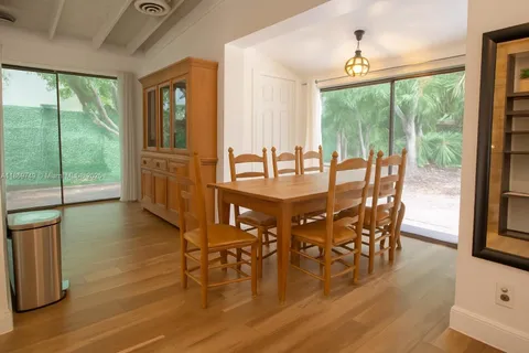 a dining room with furniture window wooden floor