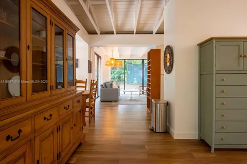 a view of hallway with livingroom and wooden floor