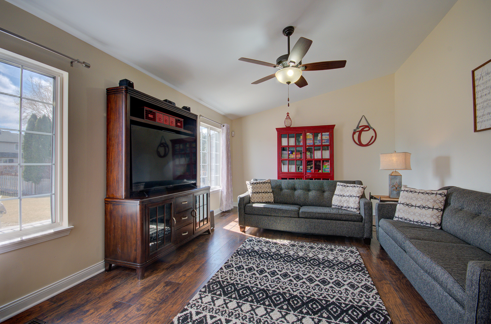 1504 Bluestem Lane Minooka, IL 60447 - Photo 11 of 27 a living room with furniture and a flat screen tv
