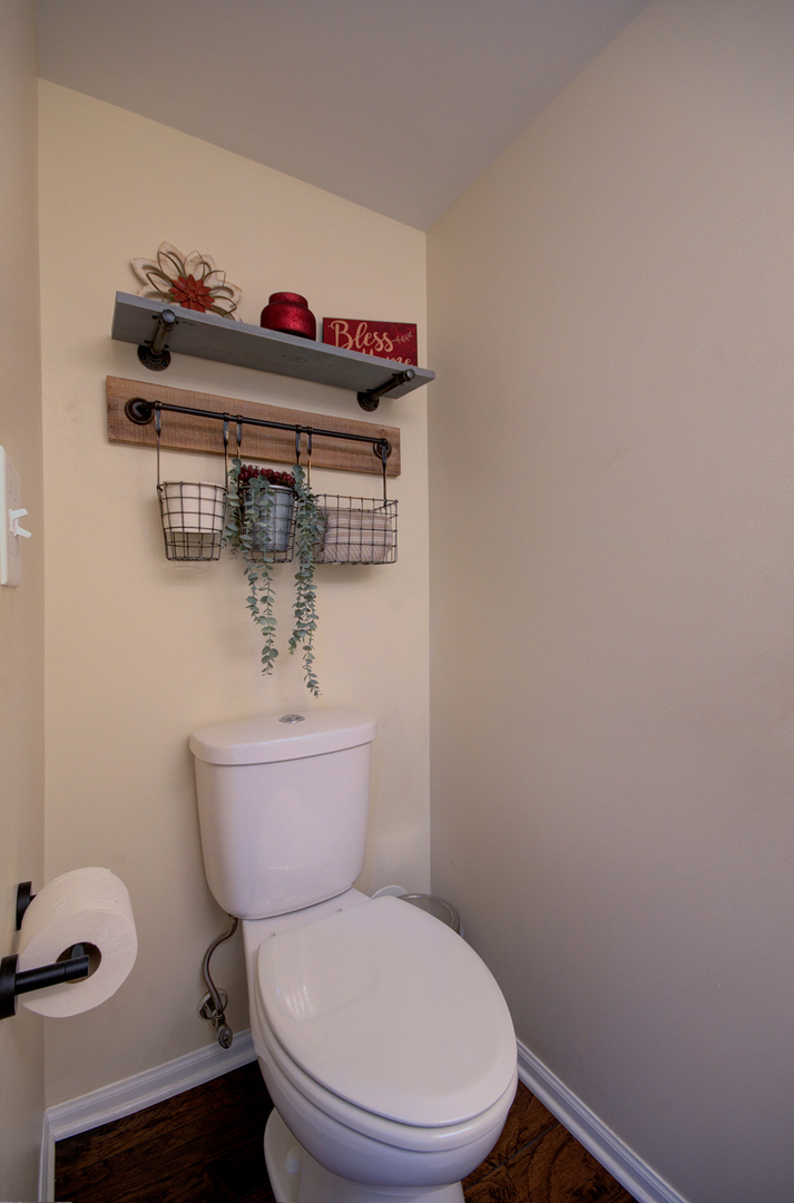 1504 Bluestem Lane Minooka, IL 60447 - Photo 13 of 27 a white toilet sitting next to a bathroom sink