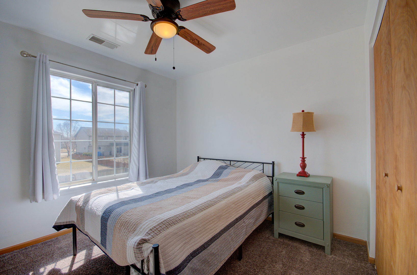 1504 Bluestem Lane Minooka, IL 60447 - Photo 19 of 27 a bedroom with a bed and a chandelier