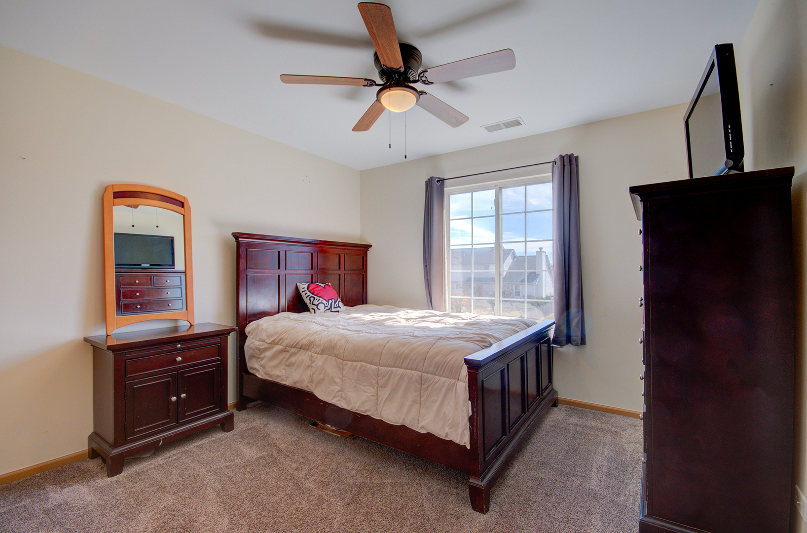 1504 Bluestem Lane Minooka, IL 60447 - Photo 23 of 27 a bedroom with a bed dresser and a window