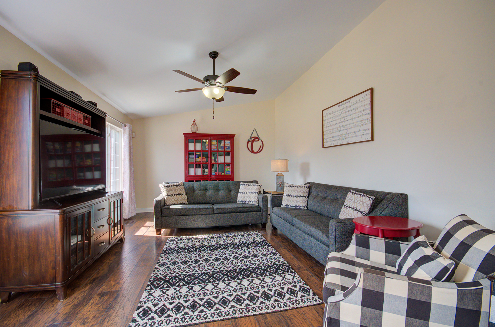 1504 Bluestem Lane Minooka, IL 60447 - Photo 10 of 27 a living room with furniture and a flat screen tv