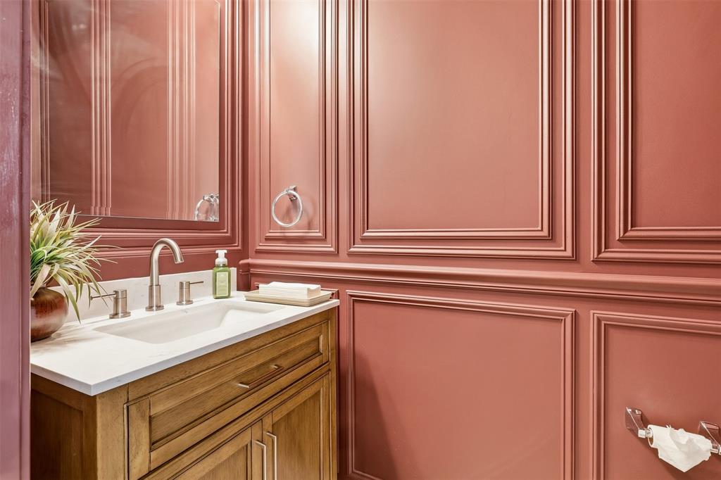 5640 Pradera Road Fort Worth, TX 76126 - Photo 27 of 35 Paneling walls, wood-finish vanity, integrated sink, brushed nickel faucet, wall-mounted mirror
