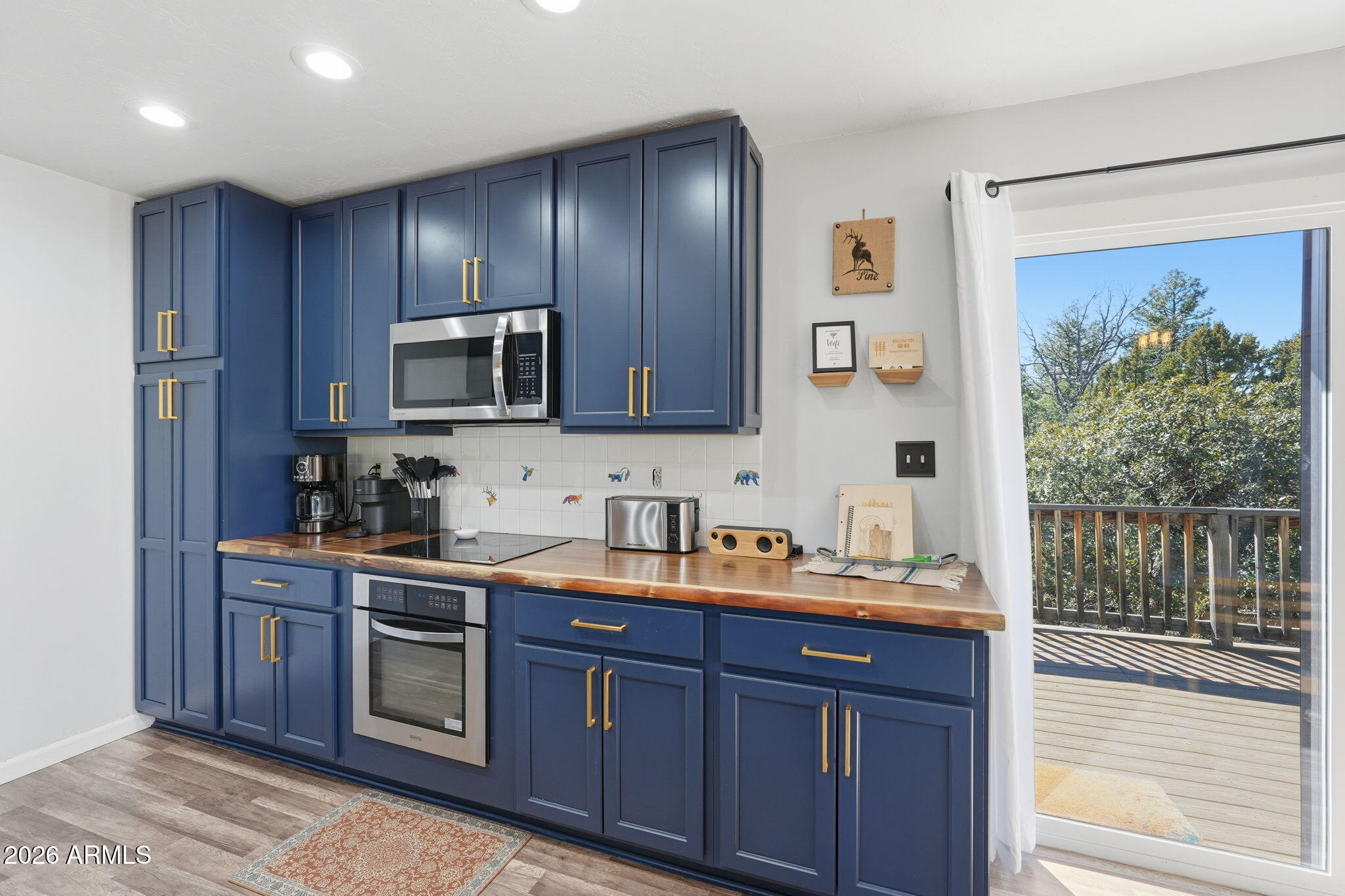 8247 Ralls Drive Pine, AZ 85544 - Photo 13 of 50 a kitchen with wooden cabinets and stainless steel appliances
