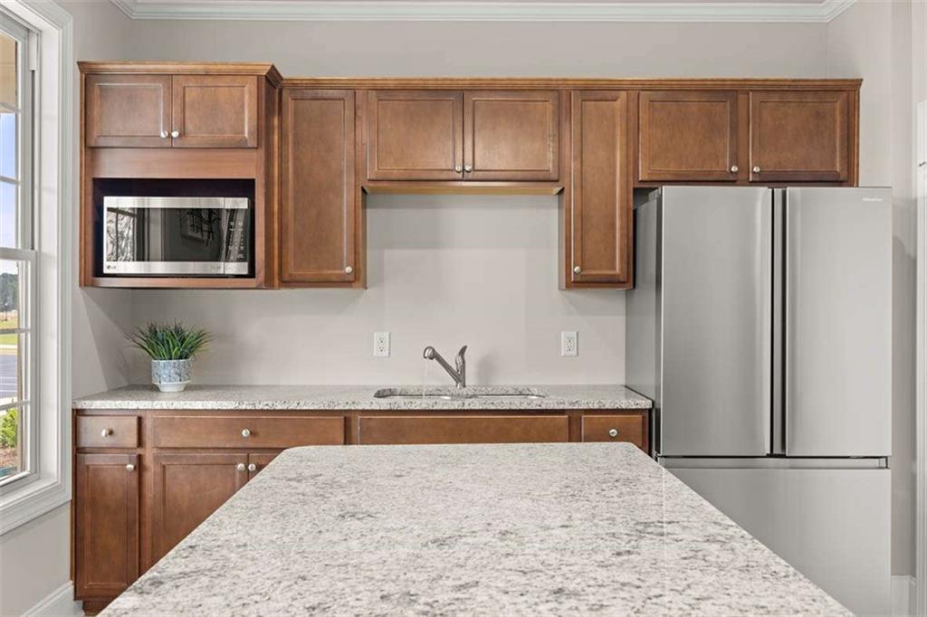 143 Defilippe Drive Statham, GA 30666 - Photo 54 of 56 a kitchen with kitchen island granite countertop cabinets and refrigerator