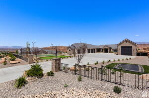 1141 East Lost Ridge Drive Washington, UT 84780 - Photo 20 of 108 Expansive concrete driveway with brick columns and wrought iron fencing