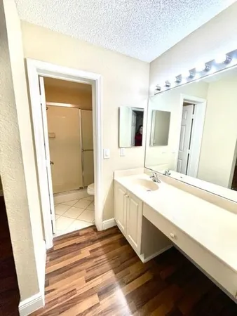 a bathroom with a double vanity sink a mirror and a shower