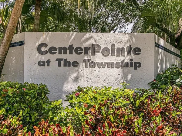 a sign that is in front of flowers