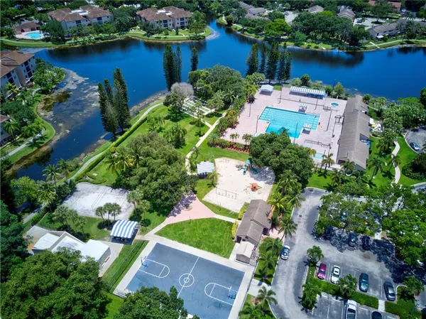 an aerial view of a house with a yard and lake view