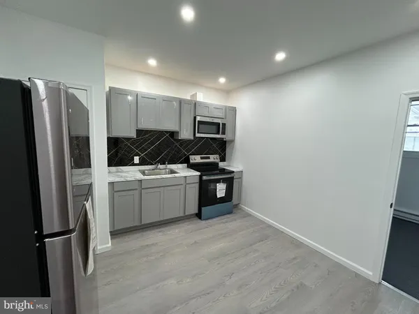 a kitchen with a refrigerator and microwave