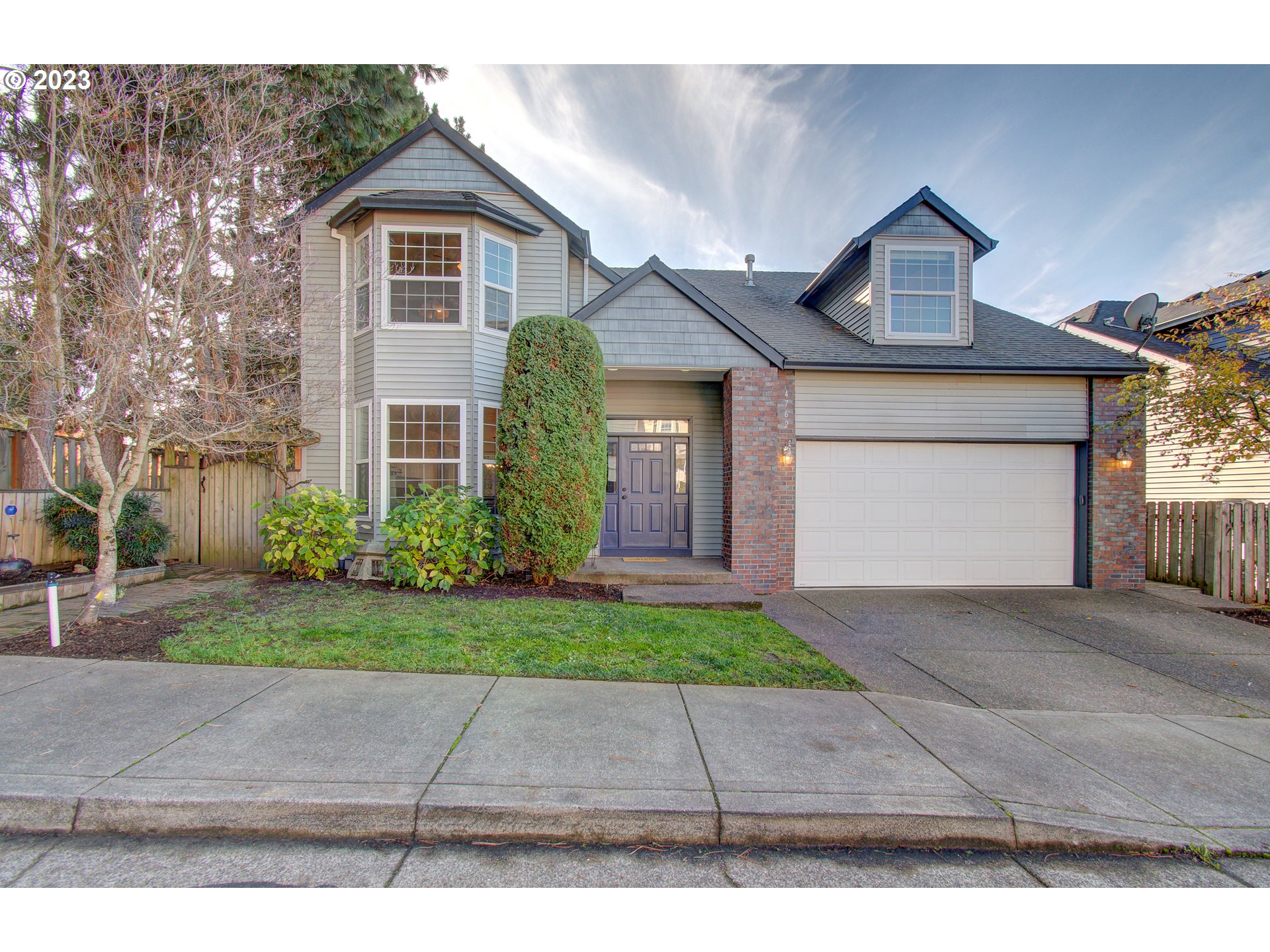 a front view of a house with a yard and a garage