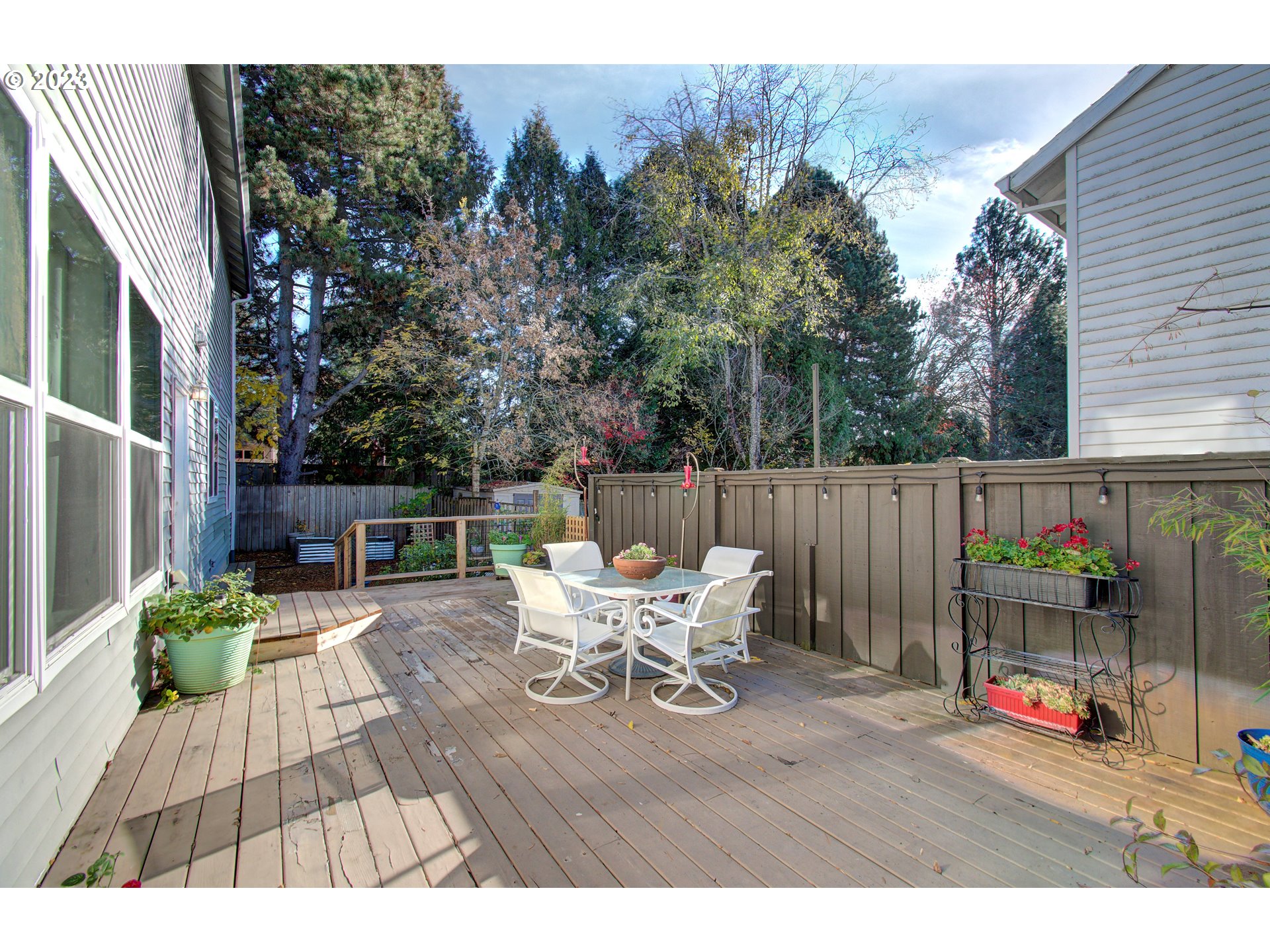 4762 Southeast 20th Terrace Gresham, OR 97080 - Photo 30 of 34 a view of a patio with table and chairs potted plants and floor to ceiling window