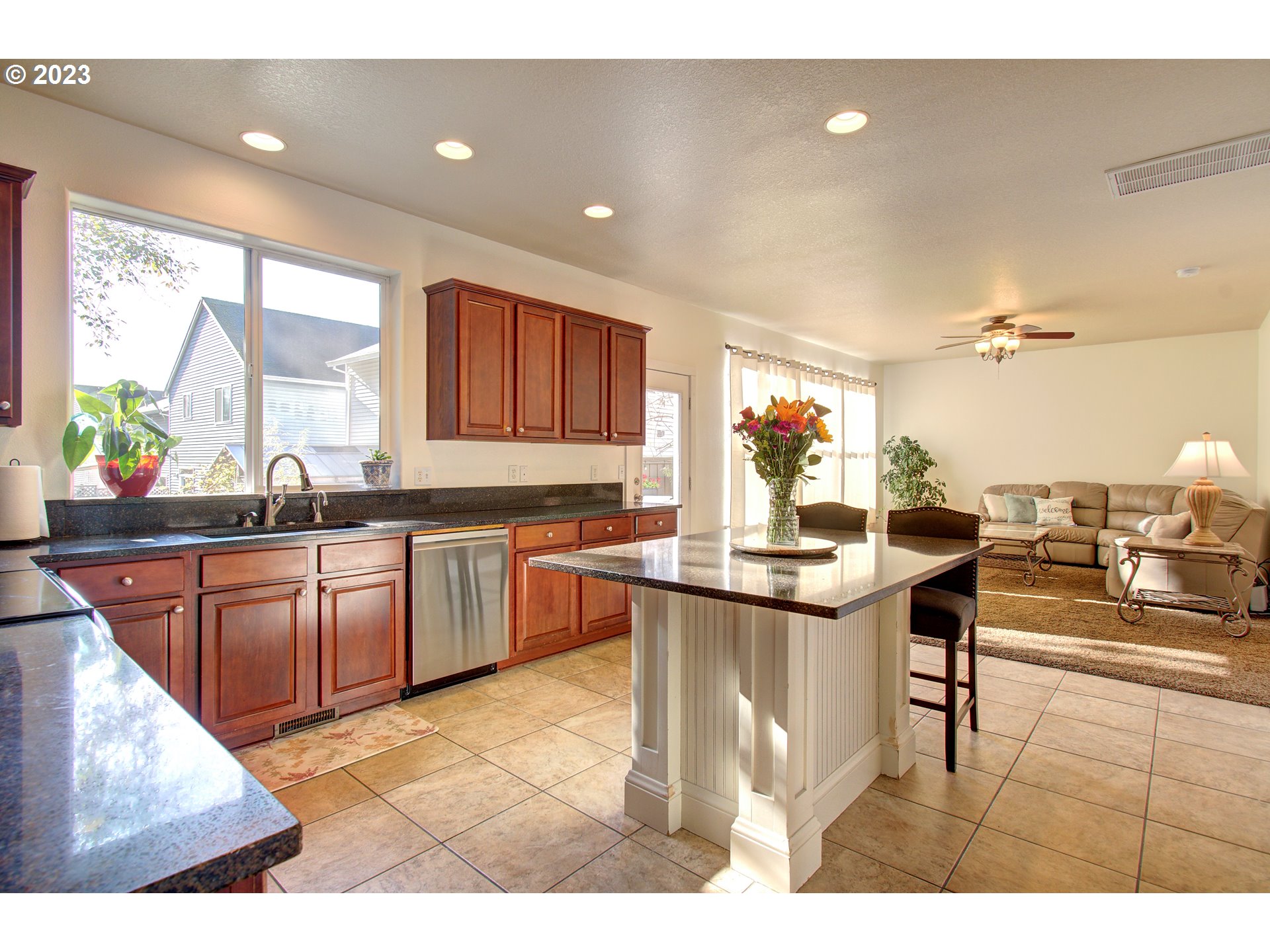 4762 Southeast 20th Terrace Gresham, OR 97080 - Photo 6 of 34 a kitchen with stainless steel appliances kitchen island granite countertop a sink and cabinets