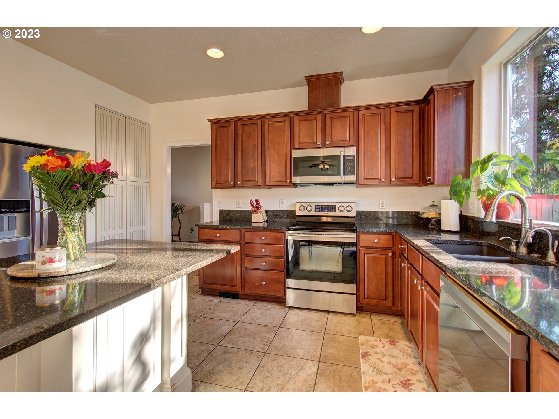 4762 Southeast 20th Terrace Gresham, OR 97080 - Photo 8 of 34 a kitchen with kitchen island granite countertop a sink stainless steel appliances and cabinets
