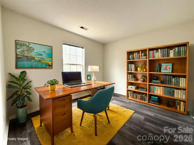 a workspace with furniture and bookshelf