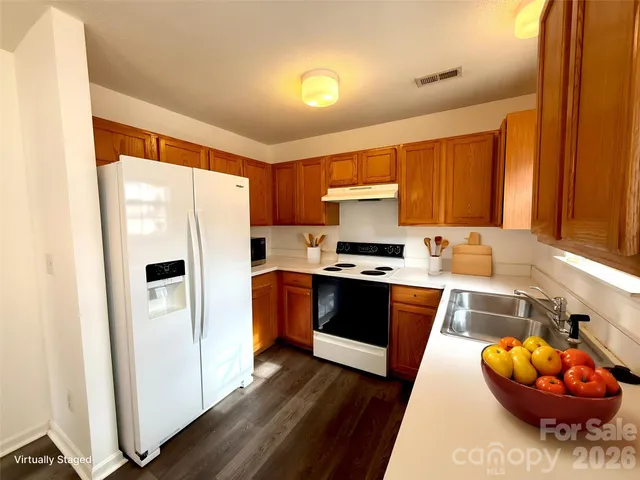 a kitchen with stainless steel appliances a refrigerator sink and cabinets