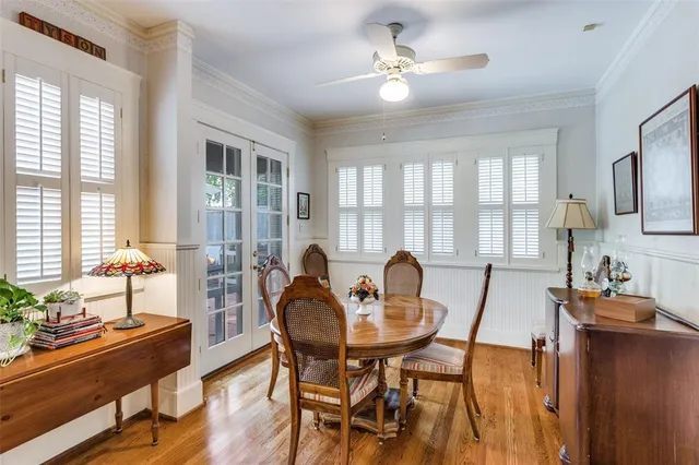 a view of a dining room with furniture a chandelier and wooden floor