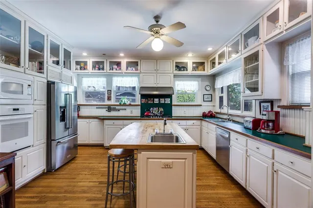 a kitchen with stainless steel appliances granite countertop a sink and cabinets