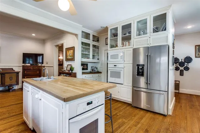a kitchen with a refrigerator and a stove top oven