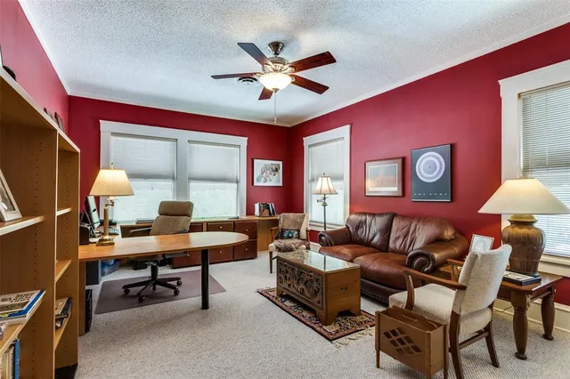 a work room with furniture and a large window