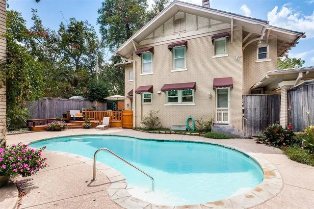 a view of a house with swimming pool and sitting area