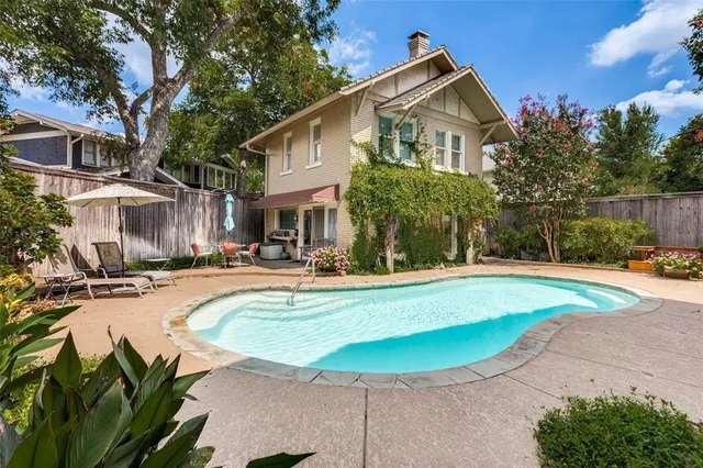 a view of a house with swimming pool and sitting area