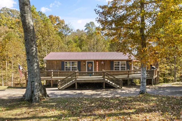 a view of a balcony with two chairs and a stove