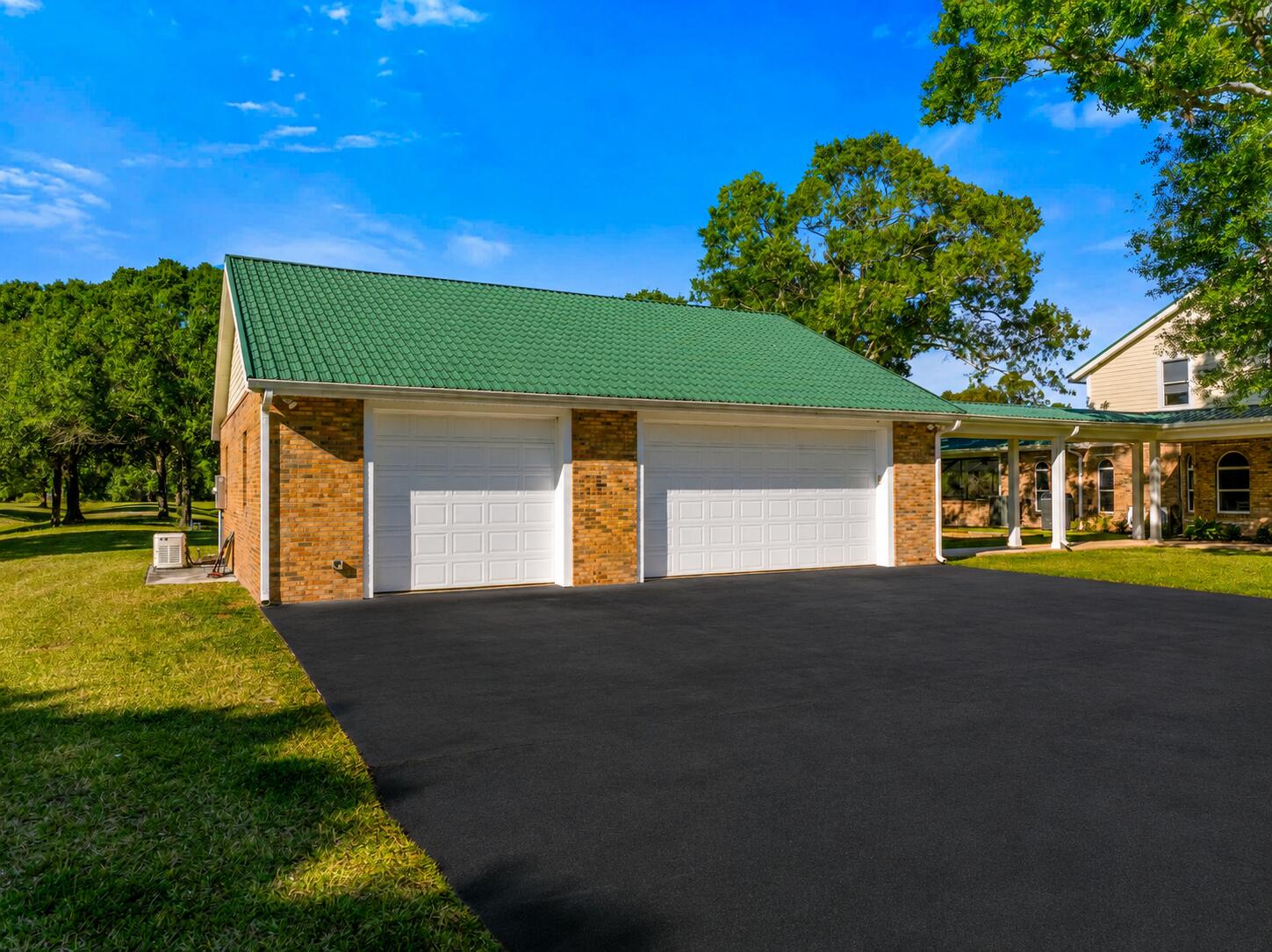8686 Andrews Avenue Fort Pierce, FL 34945 - Photo 67 of 76 a front view of a house with a yard and garage