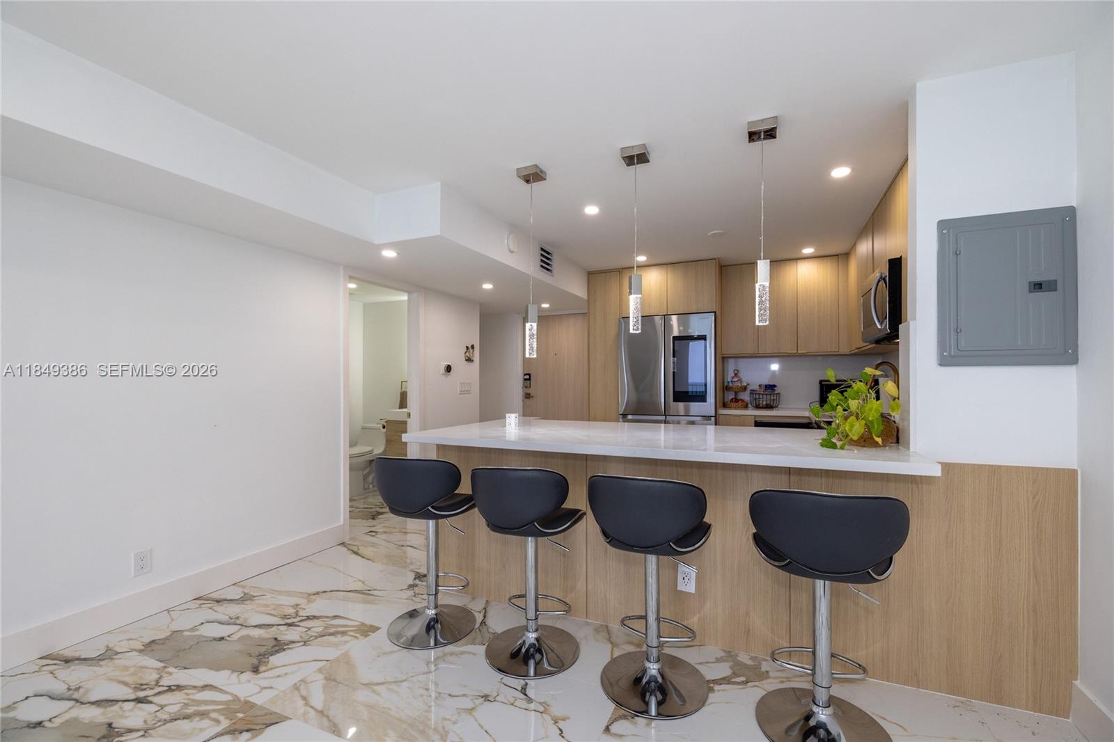 400 North Surf Road, Unit 1002 Hollywood, FL 33019 - Photo 12 of 43 a kitchen with a dining table and chairs