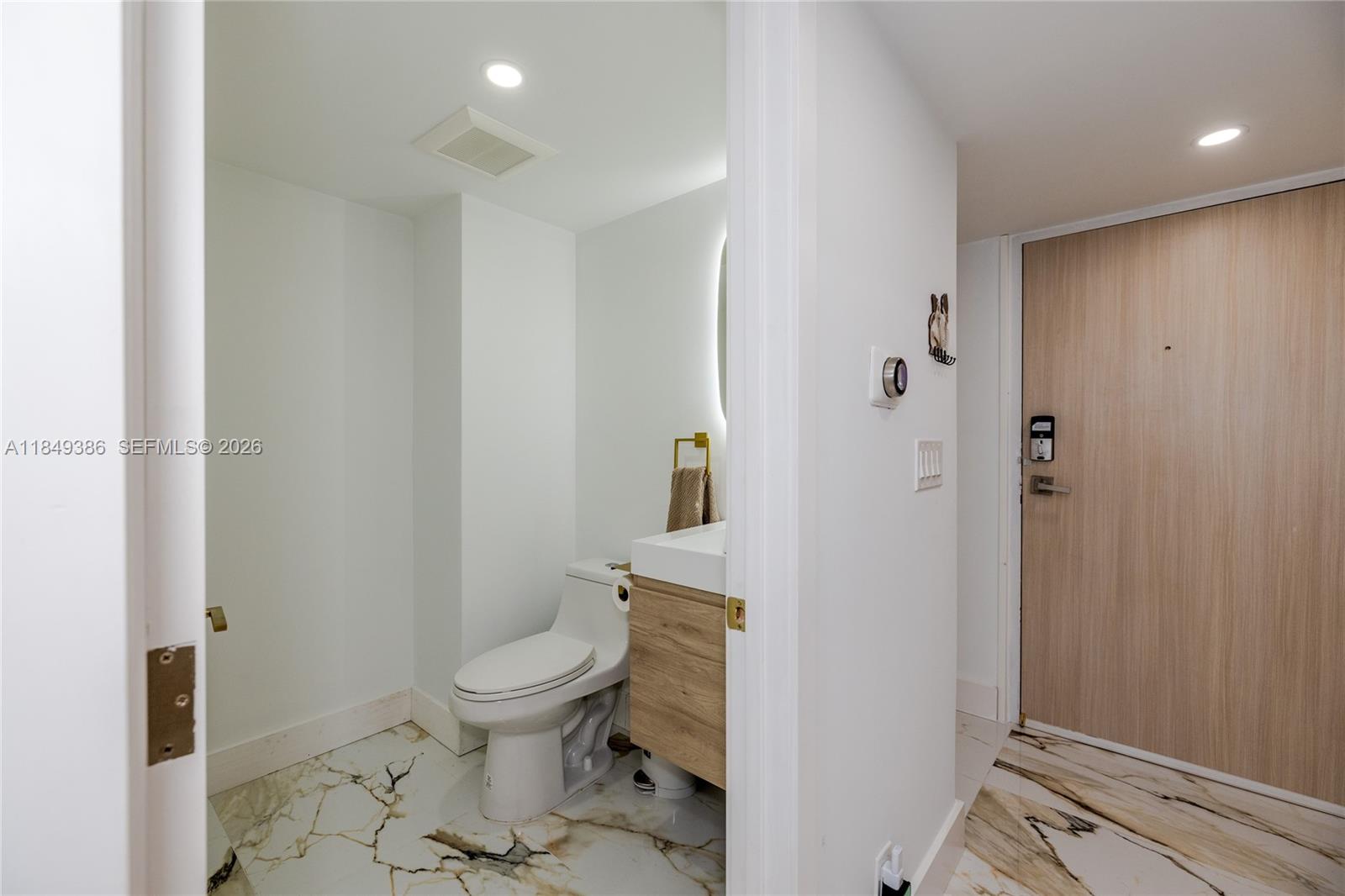 400 North Surf Road, Unit 1002 Hollywood, FL 33019 - Photo 13 of 43 a bathroom with a toilet and a shower