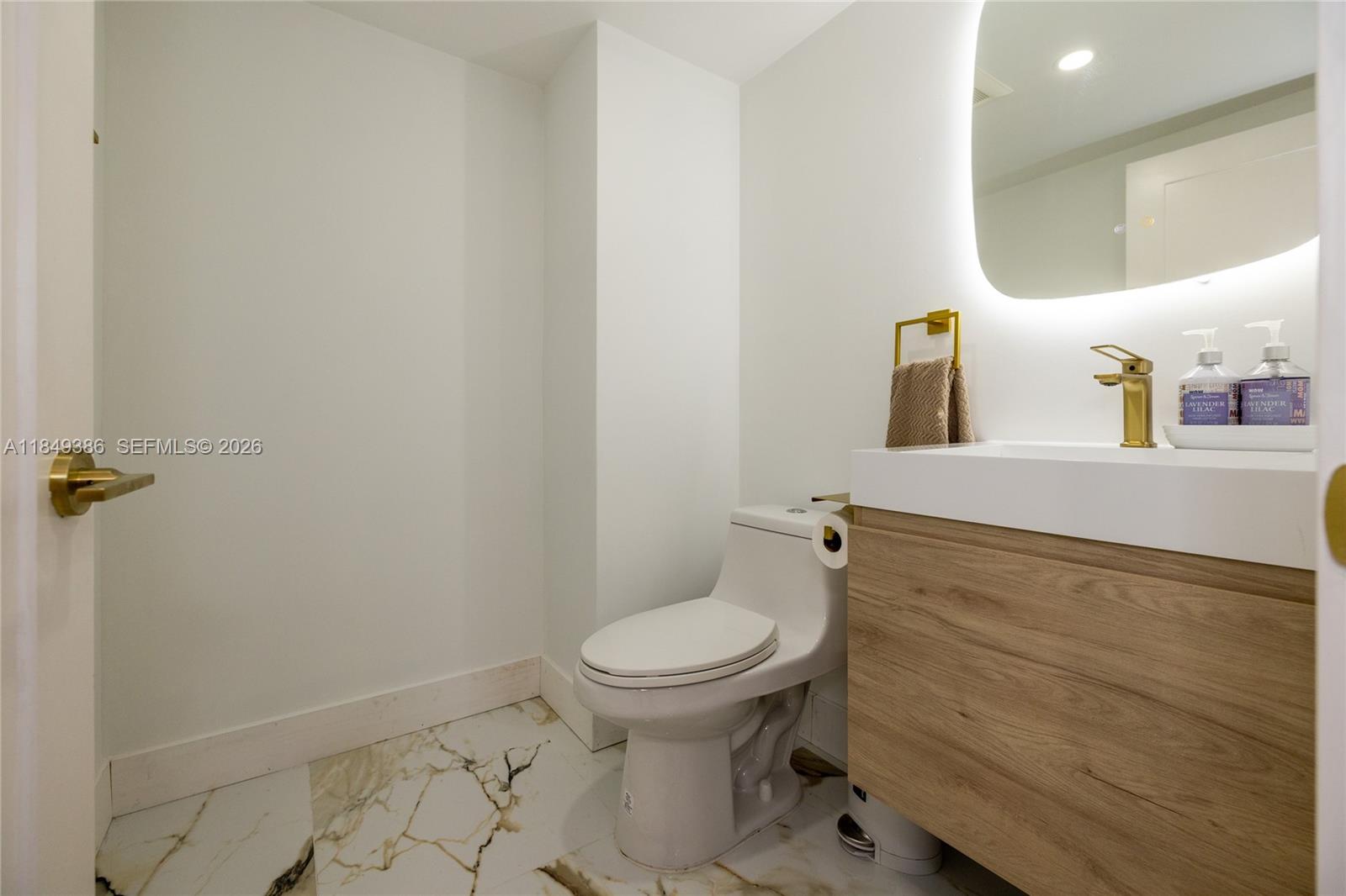 400 North Surf Road, Unit 1002 Hollywood, FL 33019 - Photo 16 of 43 a bathroom with a toilet and a sink