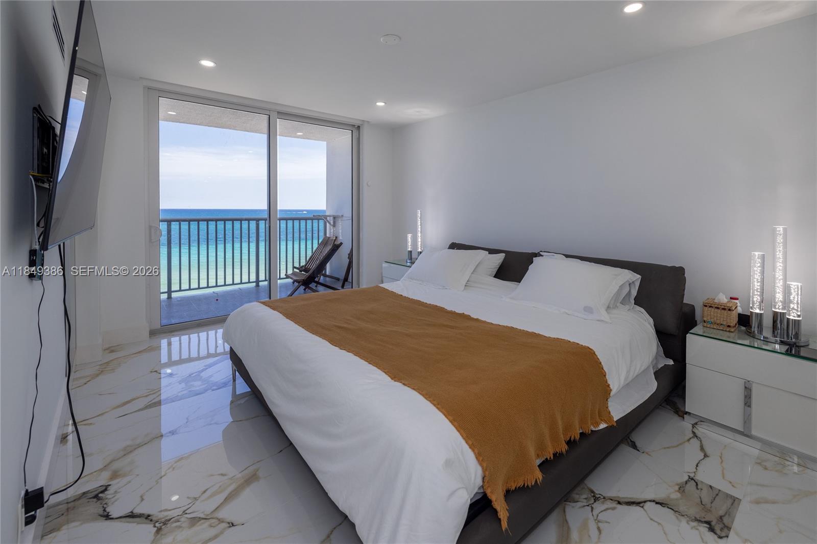 400 North Surf Road, Unit 1002 Hollywood, FL 33019 - Photo 19 of 43 a bed sitting in a bedroom next to a window