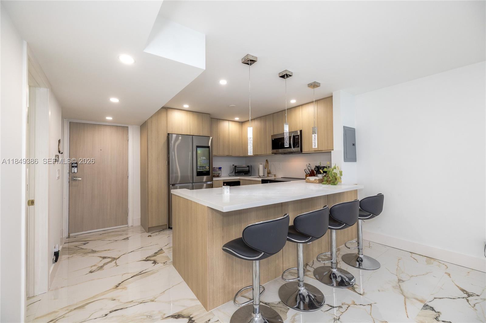 400 North Surf Road, Unit 1002 Hollywood, FL 33019 - Photo 2 of 43 a large kitchen with a table and chairs