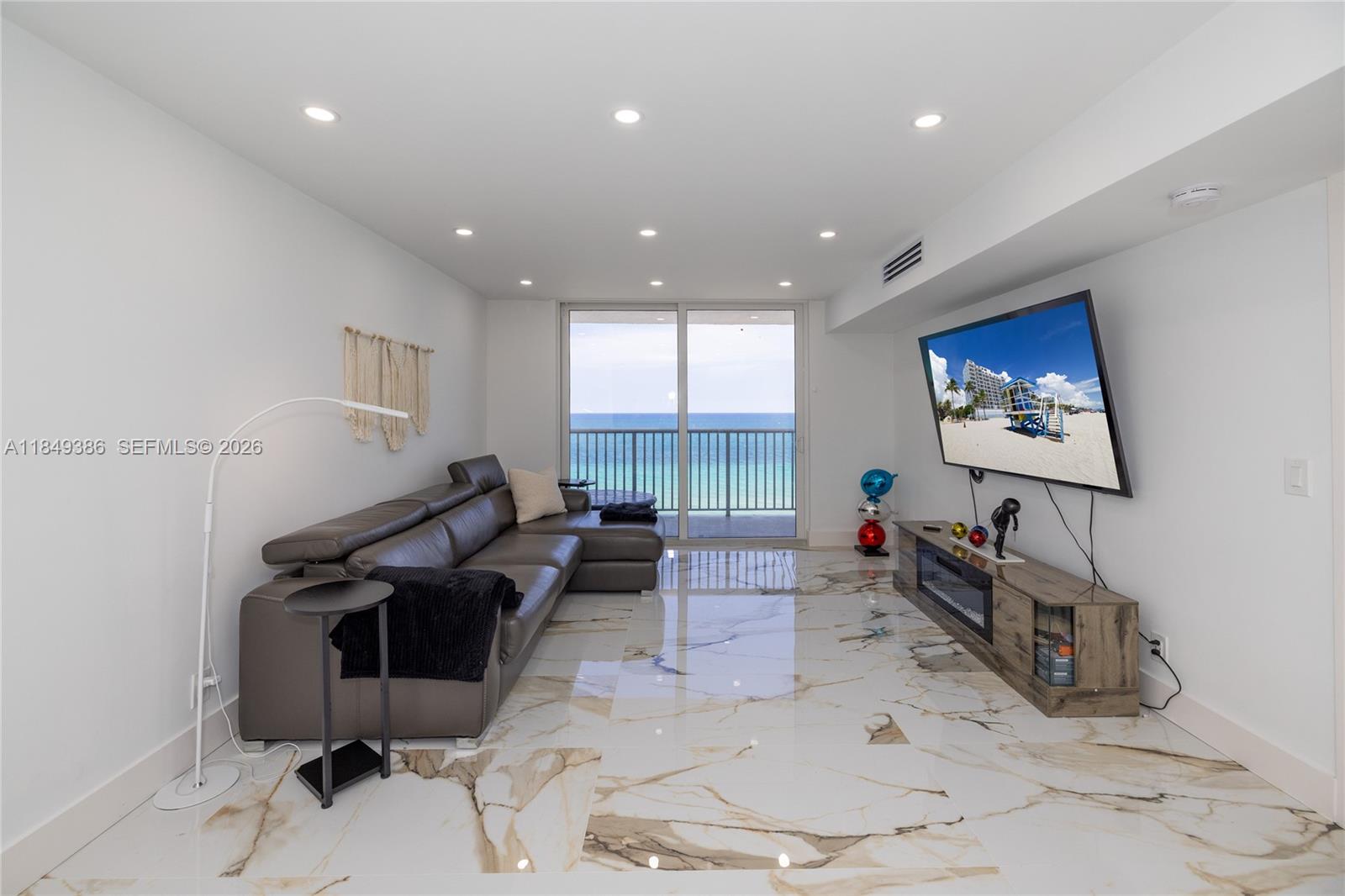 400 North Surf Road, Unit 1002 Hollywood, FL 33019 - Photo 21 of 43 a living room with furniture a rug and a flat screen tv
