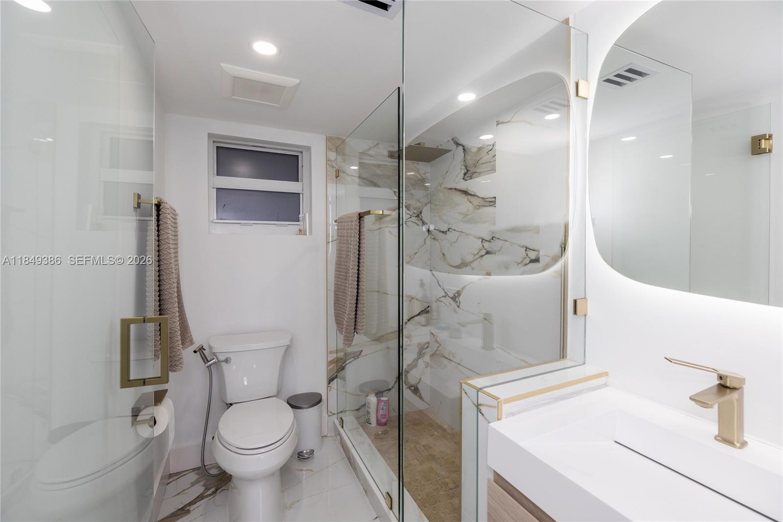 400 North Surf Road, Unit 1002 Hollywood, FL 33019 - Photo 22 of 43 a bathroom with a sink toilet and shower