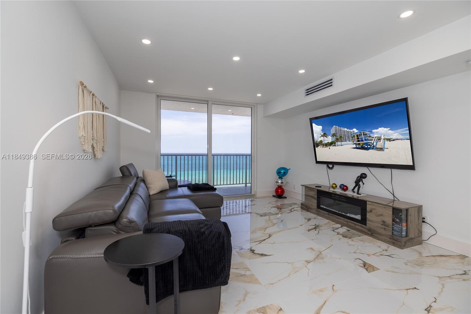 400 North Surf Road, Unit 1002 Hollywood, FL 33019 - Photo 3 of 43 a living room with furniture and a flat screen tv