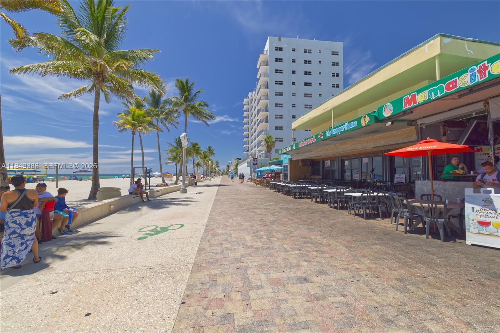 400 North Surf Road, Unit 1002 Hollywood, FL 33019 - Photo 32 of 43 a view of a patio with a table and chairs under an umbrella