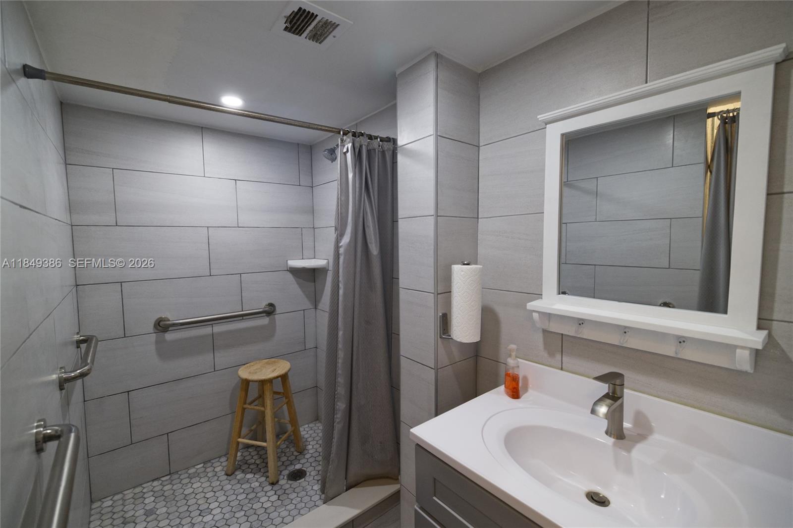 400 North Surf Road, Unit 1002 Hollywood, FL 33019 - Photo 40 of 43 a bathroom with a sink and a mirror