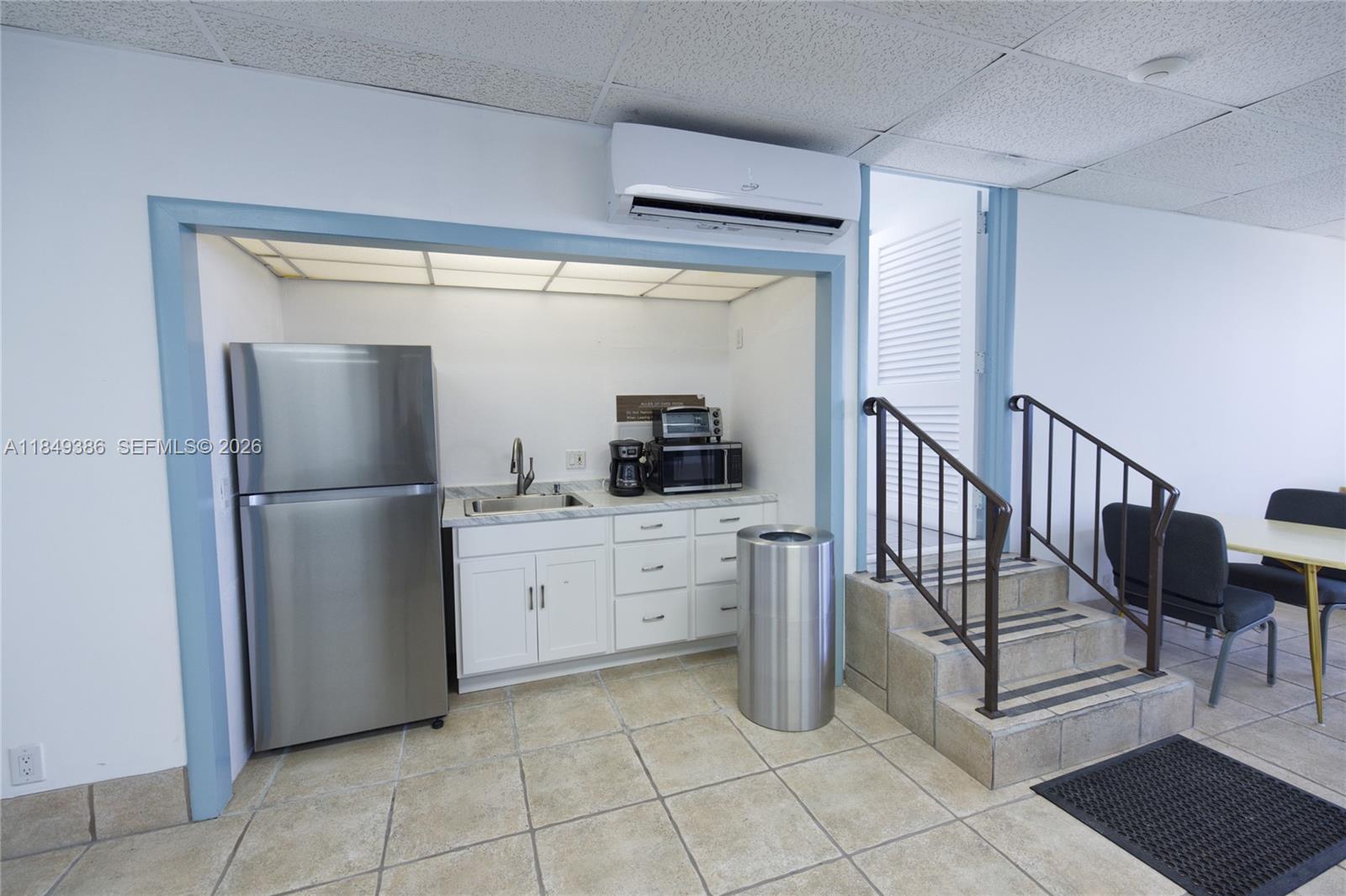 400 North Surf Road, Unit 1002 Hollywood, FL 33019 - Photo 43 of 43 a kitchen with white cabinets a refrigerator and a sink