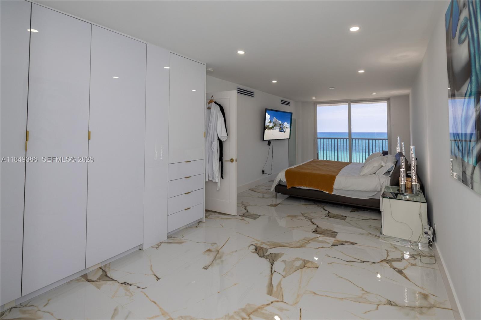 400 North Surf Road, Unit 1002 Hollywood, FL 33019 - Photo 5 of 43 a bedroom with a bed and a window