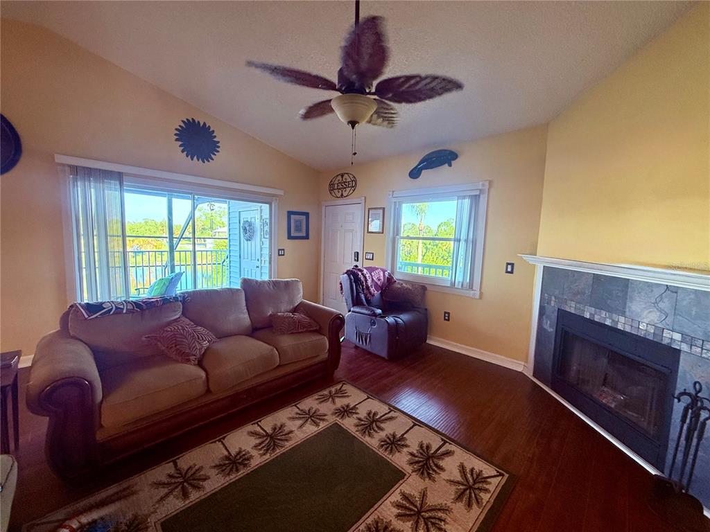 3338 Fernleaf Drive Hernando Beach, FL 34607 - Photo 12 of 69 a living room with furniture and a fireplace
