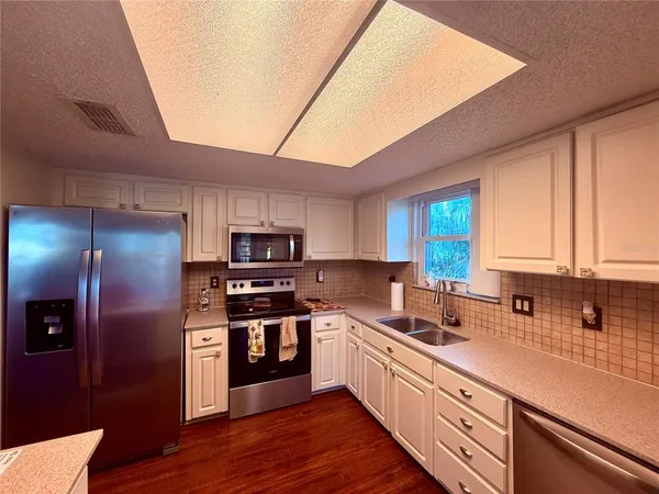 a view of room with window and wooden floor