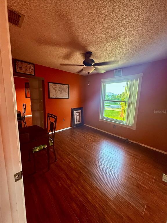 3338 Fernleaf Drive Hernando Beach, FL 34607 - Photo 19 of 69 a view of an empty room with a window and wooden floor