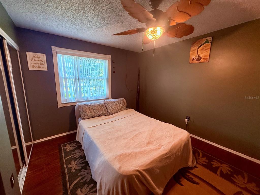 3338 Fernleaf Drive Hernando Beach, FL 34607 - Photo 23 of 69 a bedroom with a bed and a window