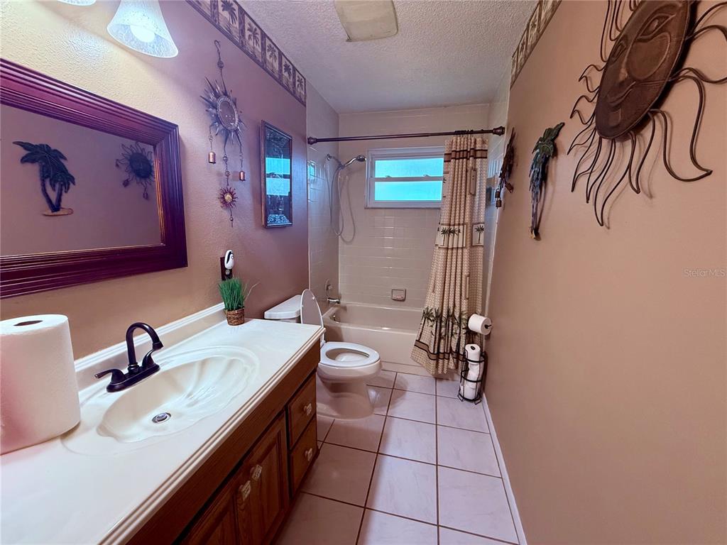 3338 Fernleaf Drive Hernando Beach, FL 34607 - Photo 25 of 69 a spacious bathroom with a double vanity sink a mirror and a shower