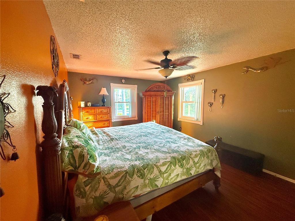 3338 Fernleaf Drive Hernando Beach, FL 34607 - Photo 26 of 69 a bed room with a bed and a mirror