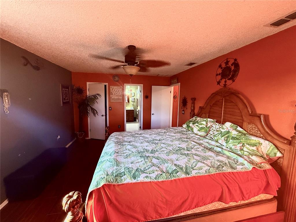 3338 Fernleaf Drive Hernando Beach, FL 34607 - Photo 27 of 69 a bedroom with a bed and a mirror
