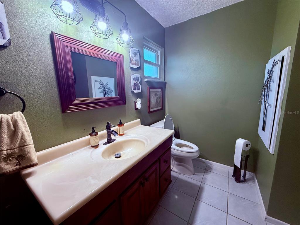 3338 Fernleaf Drive Hernando Beach, FL 34607 - Photo 31 of 69 a bathroom with a toilet sink and mirror