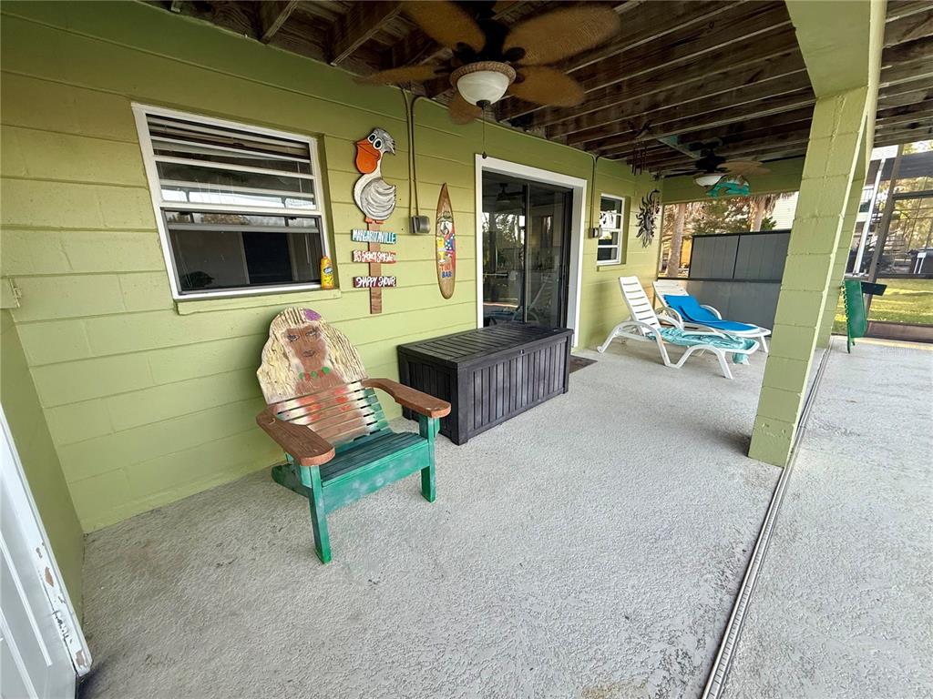 3338 Fernleaf Drive Hernando Beach, FL 34607 - Photo 48 of 69 a view of a porch with furniture and a window
